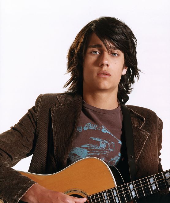 Teddy Geiger holding his guitar