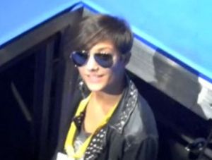 Frankie Sandford standing on a stage lift