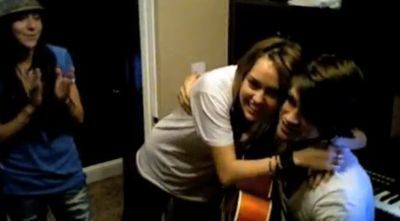 Miley Cyrus, seen here hugging boyfriend Justin Gaston as Mandy Jiroux claps in approval, are starting to Tweet each other again